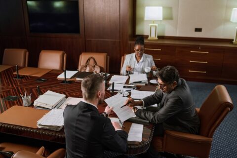 Lawyers at a table conducting a desposition